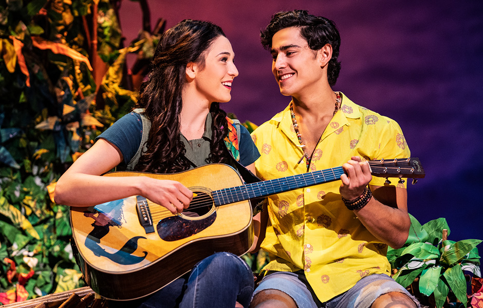 Color image of characters from Escape to Margaritaville playing guitar and looking lovingly at eachother.