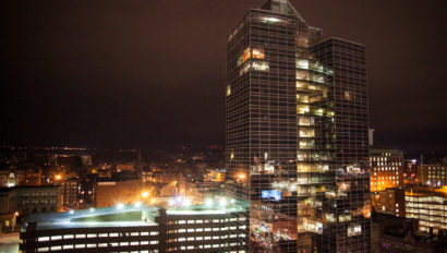 worcester skyline at night with glass building in foreground.