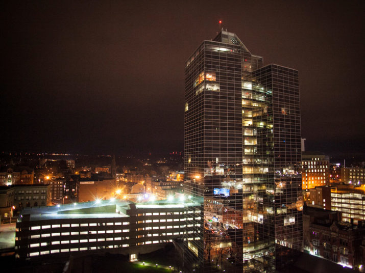 worcester skyline at night with glass building in foreground.