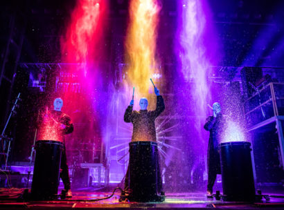 Blue Man group performing with paint.