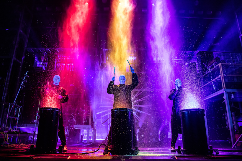 Blue Man group performing with paint.