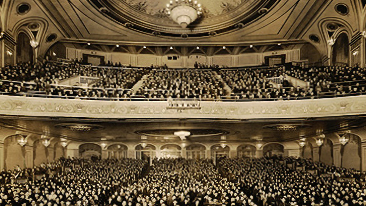 old sepia photo of hanover theatre seating filled with people.