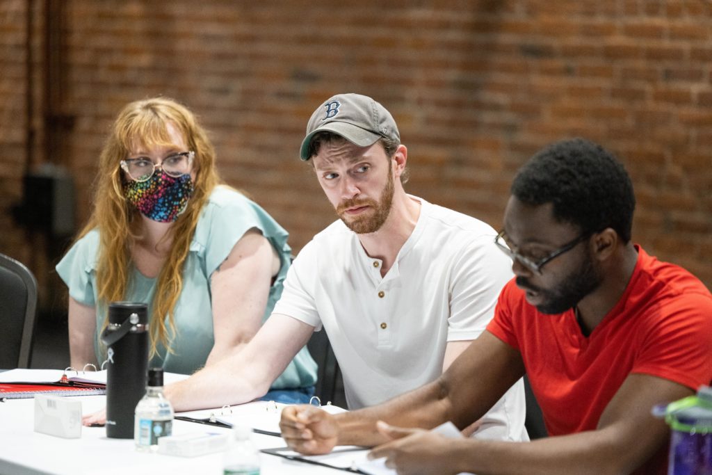 Anna MacInnis (Second Witch, u/s Lady Macbeth), Robert St. Laurence* (Malcolm, u/s Murderer) and Tokunbo Joshua Olumide (Macduff) read at the table reading of Macbeth at the BrickBox theater.