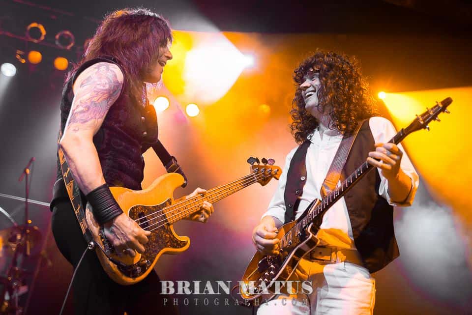 Randy Gregg and Steve Leonard from Almost Queen performing on stage.