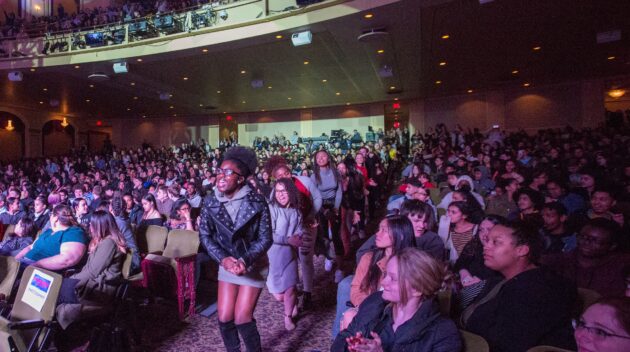 students dancing in aisles at On Your Feet!