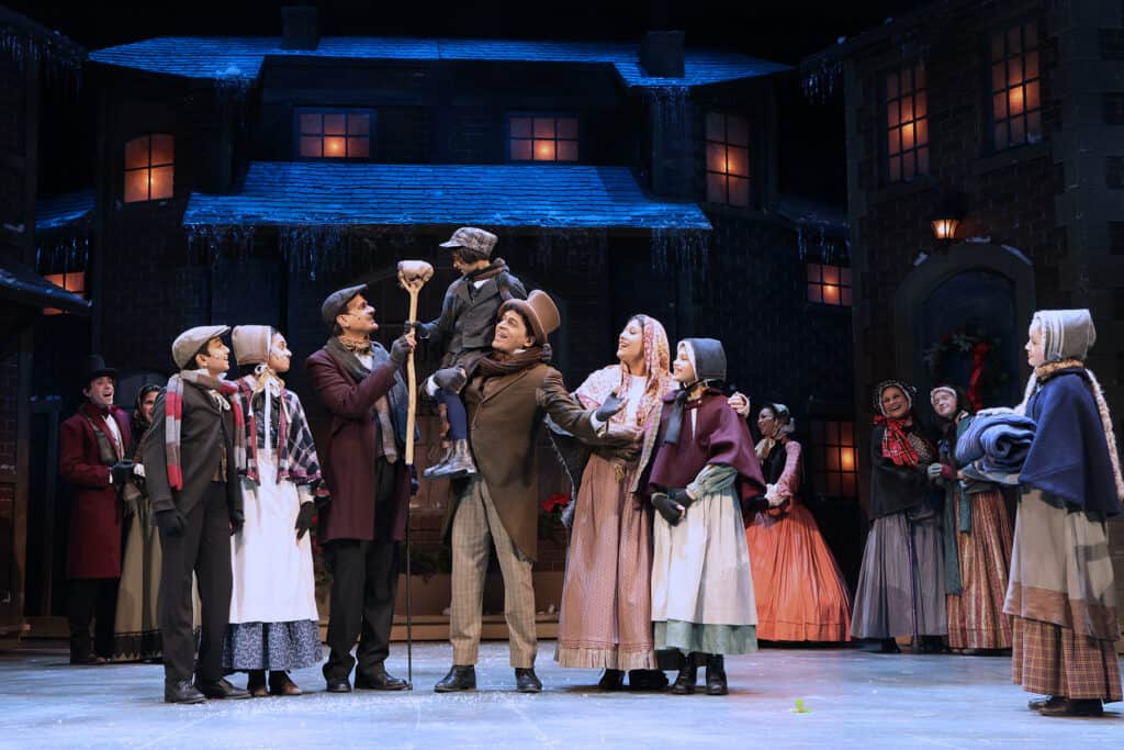 The Cratchit family on stage in London town during The Hanover Theatre's annual production of A Christmas Carol.
