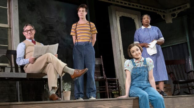 The costumed cast of To Kill A Mockingbird onstage looking off-camera.
