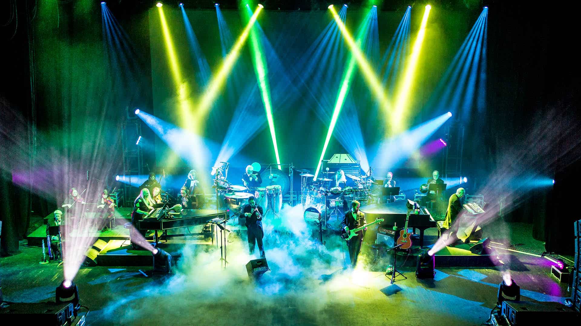 Mannheim Steamroller Christmas by Chip Davis. A shot of the band playing their instruments with fog machines, green, pink, and blue lights. Photo credit to Matt Christine Photography.