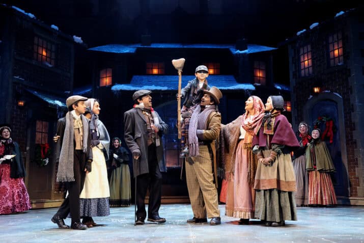 A Christmas Carol (2023 production) Cast singing together onstage during a performance, David Costa Photography 2023