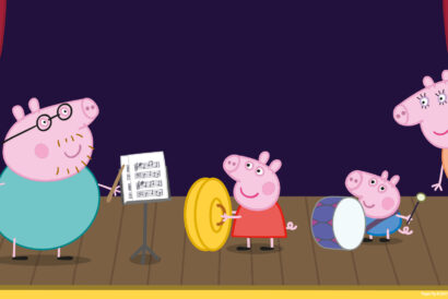 Peppa Pig - Hanover Theatre and Conservatory Peppa Pig and her family perform on stage with musical instruments. Daddy Pig conducts with a baton next to a music stand, Peppa holds a large yellow cymbal, George plays a drum with a mallet, and Mummy Pig stands smiling behind the curtain. The stage is framed by red curtains and a dark purple background.