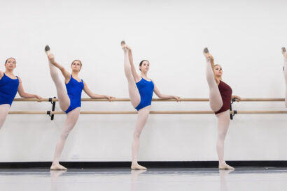Adult Stretch Strength Conditioning Ages 18+ SUMMER - Hanover Theatre and Conservatory Group of ballet students at a barre performing high leg extensions in a studio.